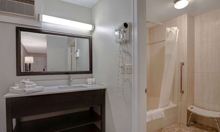 Private guest bathroom with shower and free toiletries at Days Inn Vernon.