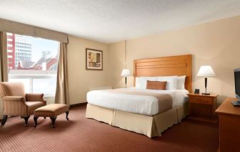 Day use room with TV, sofa, work desk and private bathroom at Days Inn Edmonton Downtown.