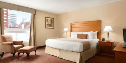 Day use room with TV, sofa, work desk and private bathroom at Days Inn Edmonton Downtown.