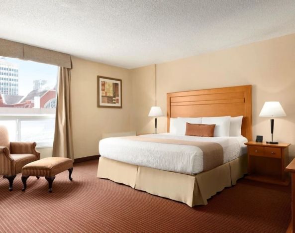 Day use room with TV, sofa, work desk and private bathroom at Days Inn Edmonton Downtown.