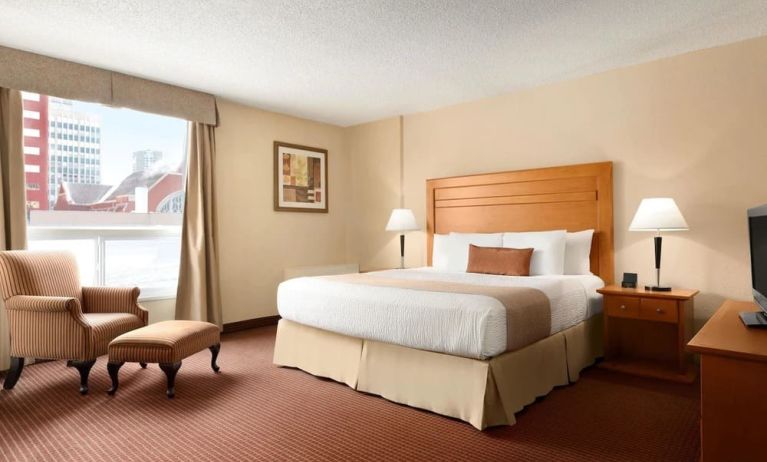 Day use room with TV, sofa, work desk and private bathroom at Days Inn Edmonton Downtown.