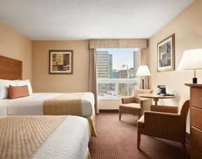 Day use twin room with TV, sofas, large window and private bathroom at Days Inn Edmonton Downtown.