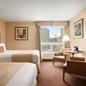 Day use twin room with TV, sofas, large window and private bathroom at Days Inn Edmonton Downtown.