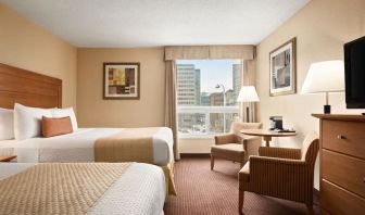 Day use twin room with TV, sofas, large window and private bathroom at Days Inn Edmonton Downtown.