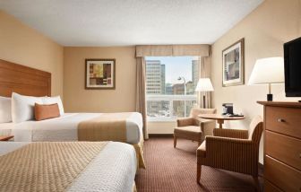 Day use twin room with TV, sofas, large window and private bathroom at Days Inn Edmonton Downtown.