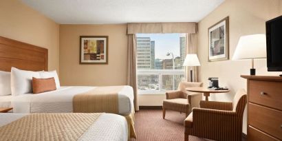 Day use twin room with TV, sofas, large window and private bathroom at Days Inn Edmonton Downtown.