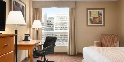 Bright and spacious day use room with TV, sofa, work desk and private bathroom at Days Inn Edmonton Downtown.