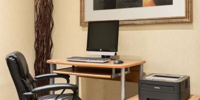 Business center with computer, printer and ergonomic chair at Days Inn Edmonton Downtown.