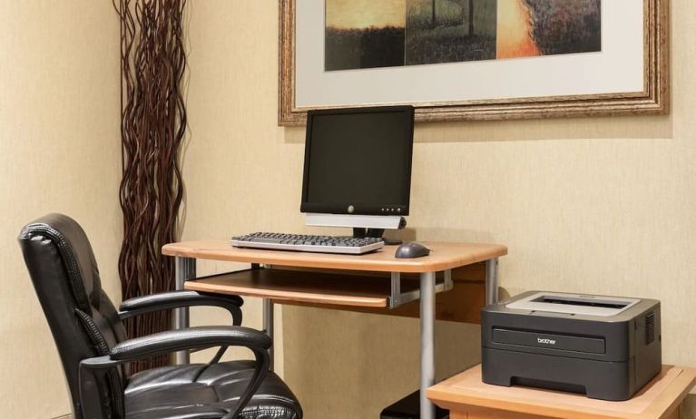 Business center with computer, printer and ergonomic chair at Days Inn Edmonton Downtown.