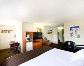 Day use room with TV, tables, sofas, mini bar, microwave and private bathroom at Riviera Motor Inn.