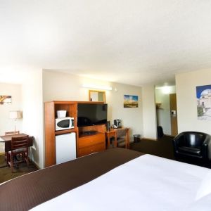 Day use room with TV, tables, sofas, mini bar, microwave and private bathroom at Riviera Motor Inn.