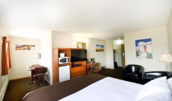 Day use room with TV, tables, sofas, mini bar, microwave and private bathroom at Riviera Motor Inn.