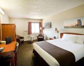 Day use room with living area, work desk and private bathroom at Riviera Motor Inn.