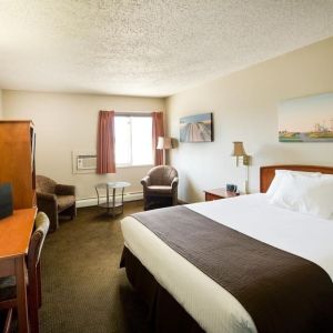 Day use room with living area, work desk and private bathroom at Riviera Motor Inn.