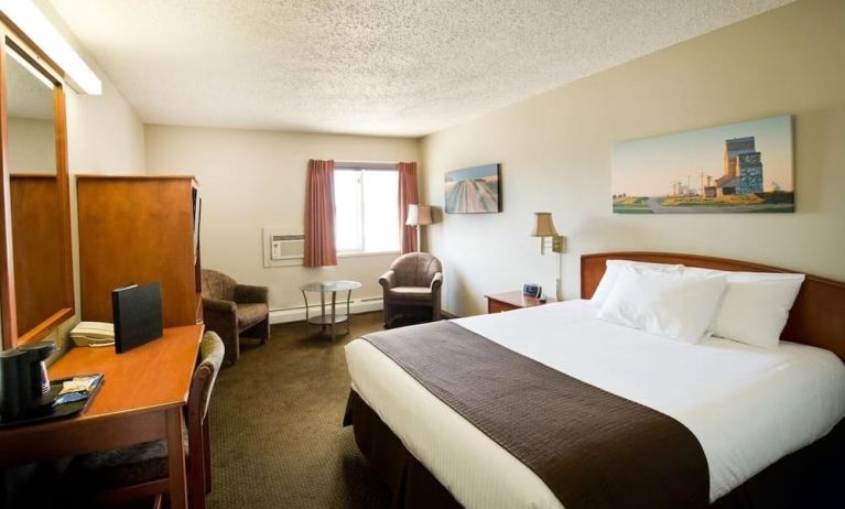 Day use room with living area, work desk and private bathroom at Riviera Motor Inn.