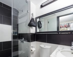 Guest bathroom with shower at The Paul Hotel, An Ascend Hotel Collection Member.