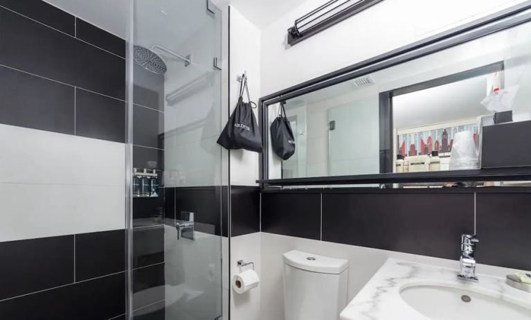 Guest bathroom with shower at The Paul Hotel, An Ascend Hotel Collection Member.