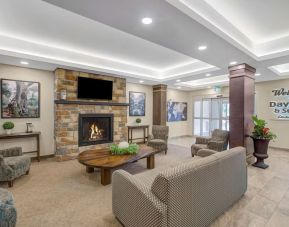 Lobby lounge area with fireplace at Days Inn & Suites By Wyndham Lindsay.