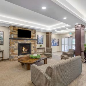 Lobby lounge area with fireplace at Days Inn & Suites By Wyndham Lindsay.