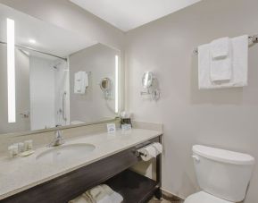 Private guest bathroom with shower and free toiletries at Days Inn & Suites By Wyndham Lindsay.