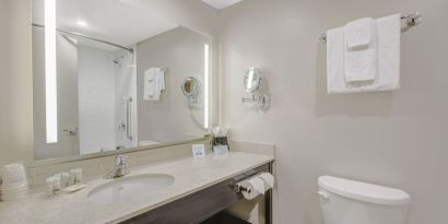 Private guest bathroom with shower and free toiletries at Days Inn & Suites By Wyndham Lindsay.