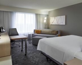 Bright day use room with TV, sofa, work desk and private bathroom at Courtyard By Marriott Toronto Airport.