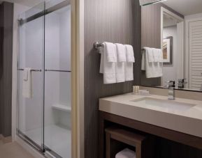 Private guest bathroom with shower and free toiletries at Courtyard By Marriott Toronto Airport.