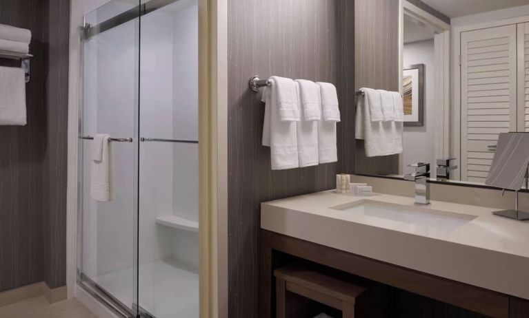 Private guest bathroom with shower and free toiletries at Courtyard By Marriott Toronto Airport.