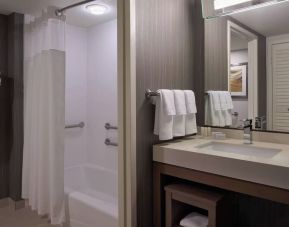 Private guest bathroom with tub and free toiletries at Courtyard By Marriott Toronto Airport.