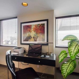 Business center with computer, printer and ergonomic chair at Comfort Inn Swift Current.