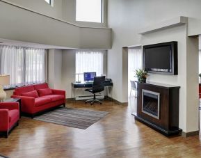 Lobby lounge area with fireplace and business center with computer, printer and ergonomic chair at Comfort Inn Sudbury Regent Street.