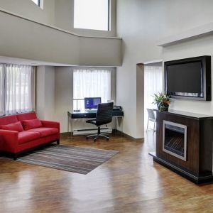 Lobby lounge area with fireplace and business center with computer, printer and ergonomic chair at Comfort Inn Sudbury Regent Street.