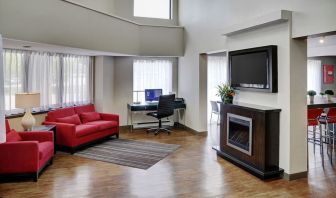 Lobby lounge area with fireplace and business center with computer, printer and ergonomic chair at Comfort Inn Sudbury Regent Street.