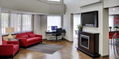 Lobby lounge area with fireplace and business center with computer, printer and ergonomic chair at Comfort Inn Sudbury Regent Street.