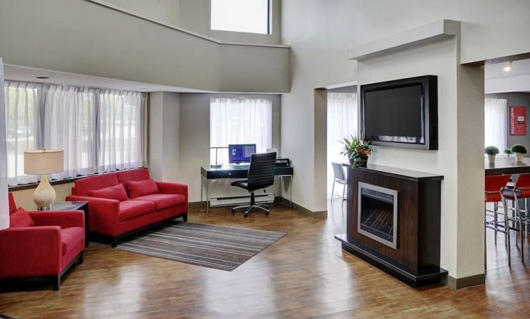 Lobby lounge area with fireplace and business center with computer, printer and ergonomic chair at Comfort Inn Sudbury Regent Street.