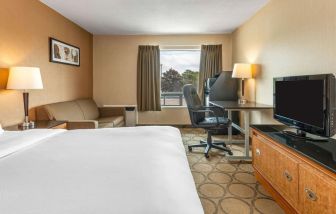 Day use room with TV, sofa, work desk and private bathroom at Comfort Inn Simcoe.