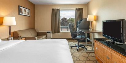 Day use room with TV, sofa, work desk and private bathroom at Comfort Inn Simcoe.