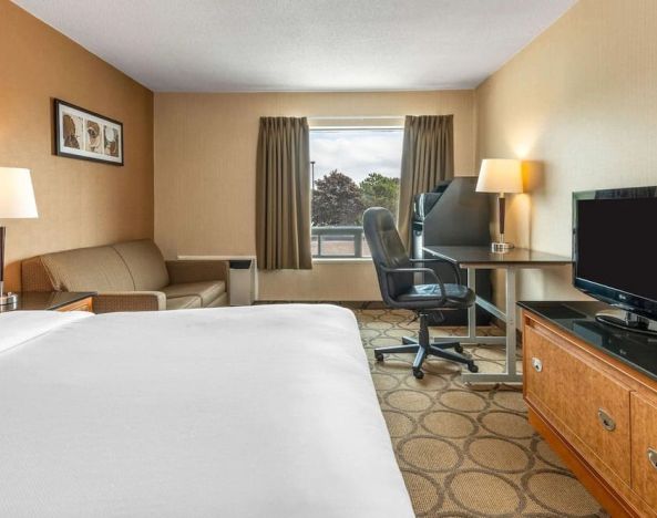 Day use room with TV, sofa, work desk and private bathroom at Comfort Inn Simcoe.