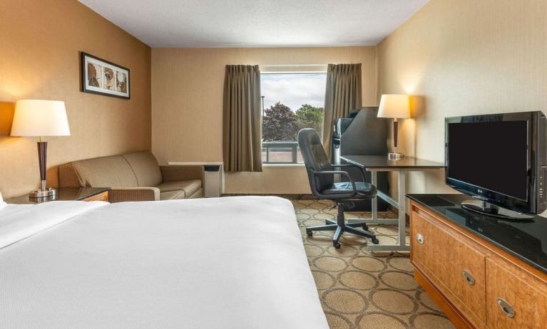 Day use room with TV, sofa, work desk and private bathroom at Comfort Inn Simcoe.