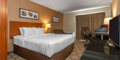 Standard day use room with TV, work desk, sofa and private bathroom at Comfort Inn Simcoe.