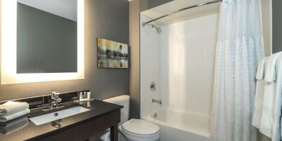 Guest bathroom with tub and free toiletries at Comfort Inn Simcoe.