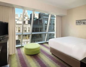 Floor-to-ceiling windows in a day use room at Best Western Premier Herald Square.