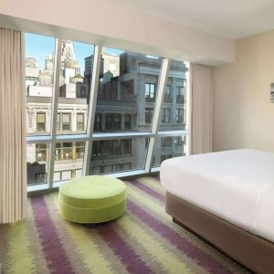 Floor-to-ceiling windows in a day use room at Best Western Premier Herald Square.