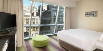 Floor-to-ceiling windows in a day use room at Best Western Premier Herald Square.