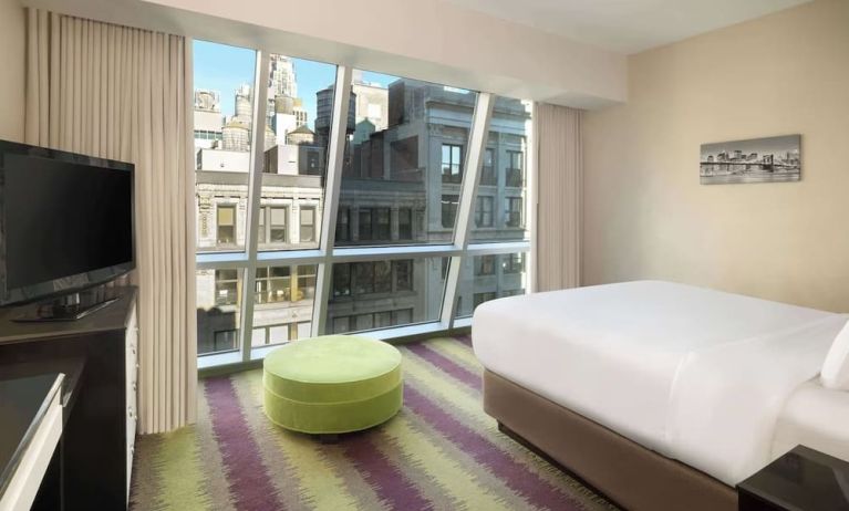 Floor-to-ceiling windows in a day use room at Best Western Premier Herald Square.