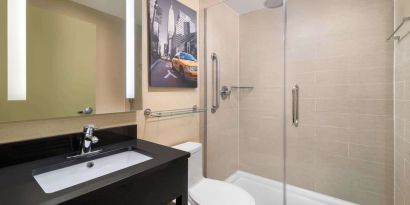 Guest bathroom with shower at Best Western Premier Herald Square.