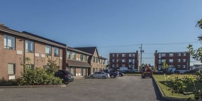 Hotel exterior and parking area at Comfort Inn Sept-Iles. 