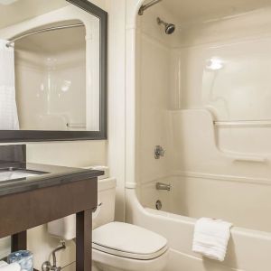 Guest bathroom with tub and free toiletries at Comfort Inn Sept-Iles. 