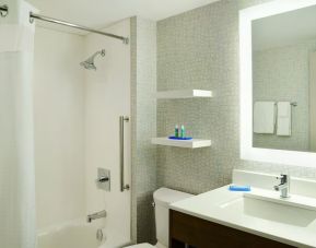 Private guest bathroom with shower and tub at Holiday Inn Express Toronto Downtown.