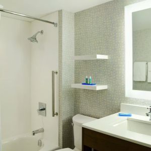 Private guest bathroom with shower and tub at Holiday Inn Express Toronto Downtown.